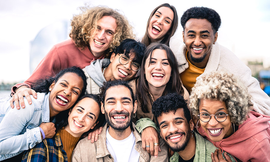 Multi ethnic guys and girls taking selfie outdoors.