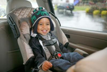 smiling infant in front facing car seat