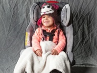 Smiling baby in careat